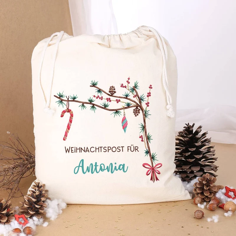 Festlicher Geschenksack mit Zweigen und Wunschtext
