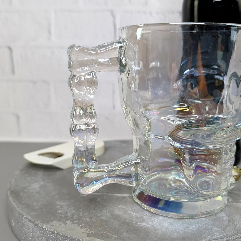 Totenkopf-Bierglas 500 ml | irisierendes Trinkglas mit Griff in Knochenform